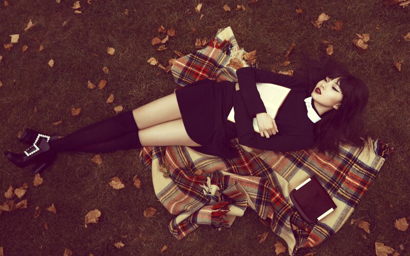 woman reading on a blanket