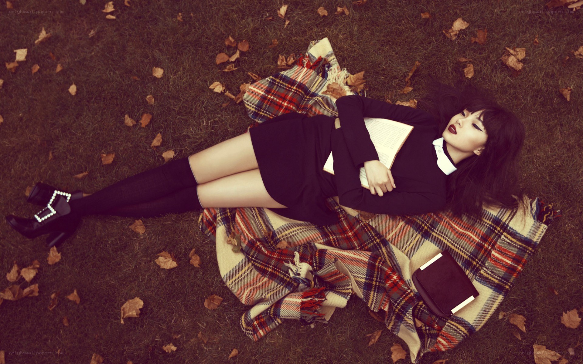 woman reading on a blanket