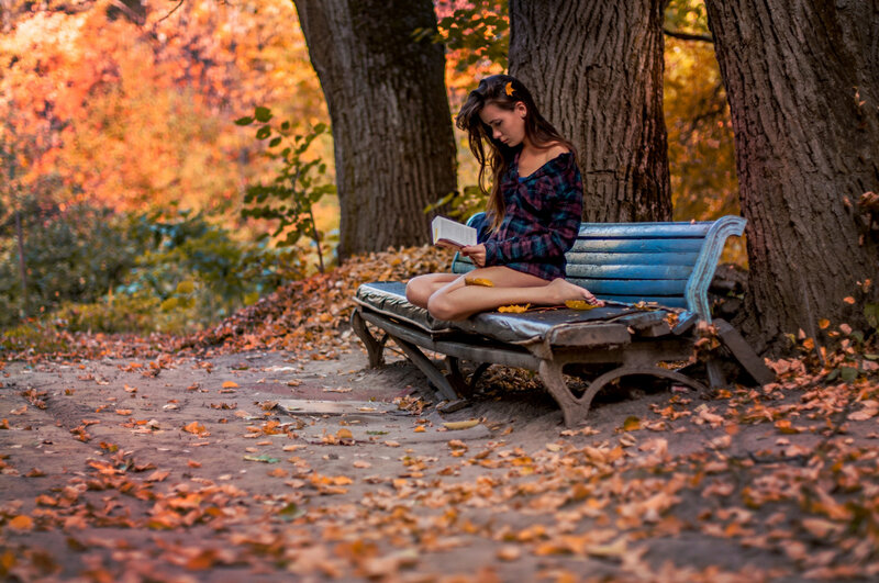 Woman Reading on Bench — Orange