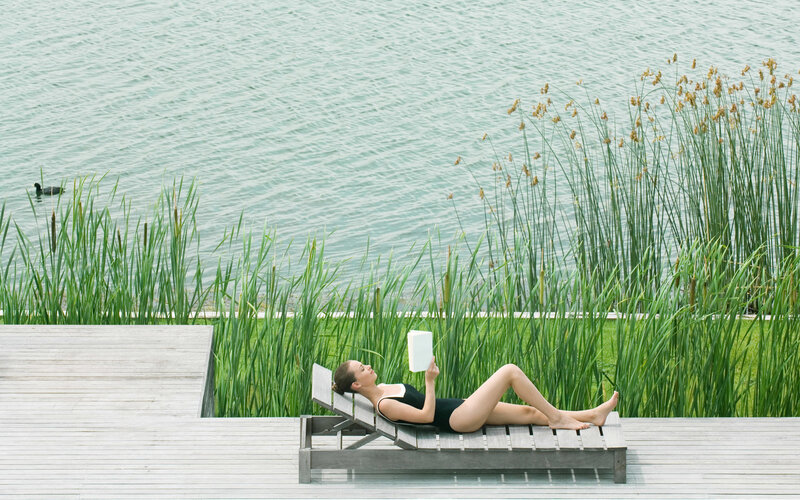 Woman Reading on Lounge Chair — Green