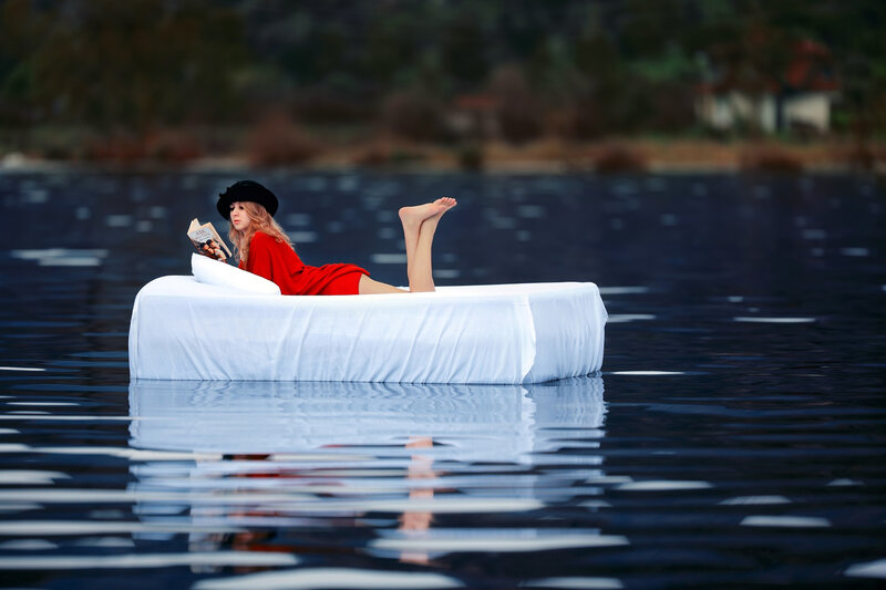 Woman Reading on Mattress