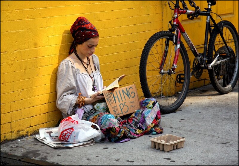 Woman reading on sidewalk