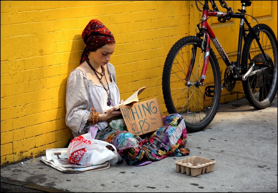 Woman reading on sidewalk