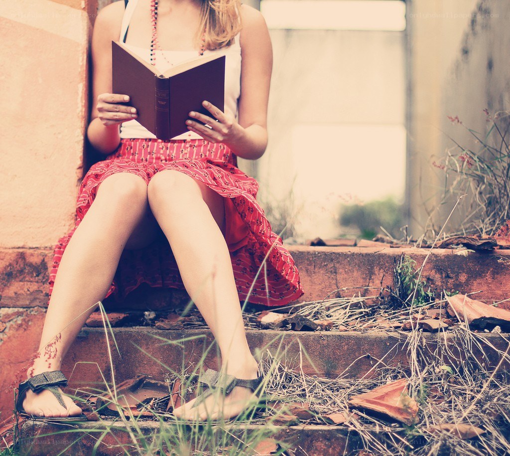 woman reading on steps