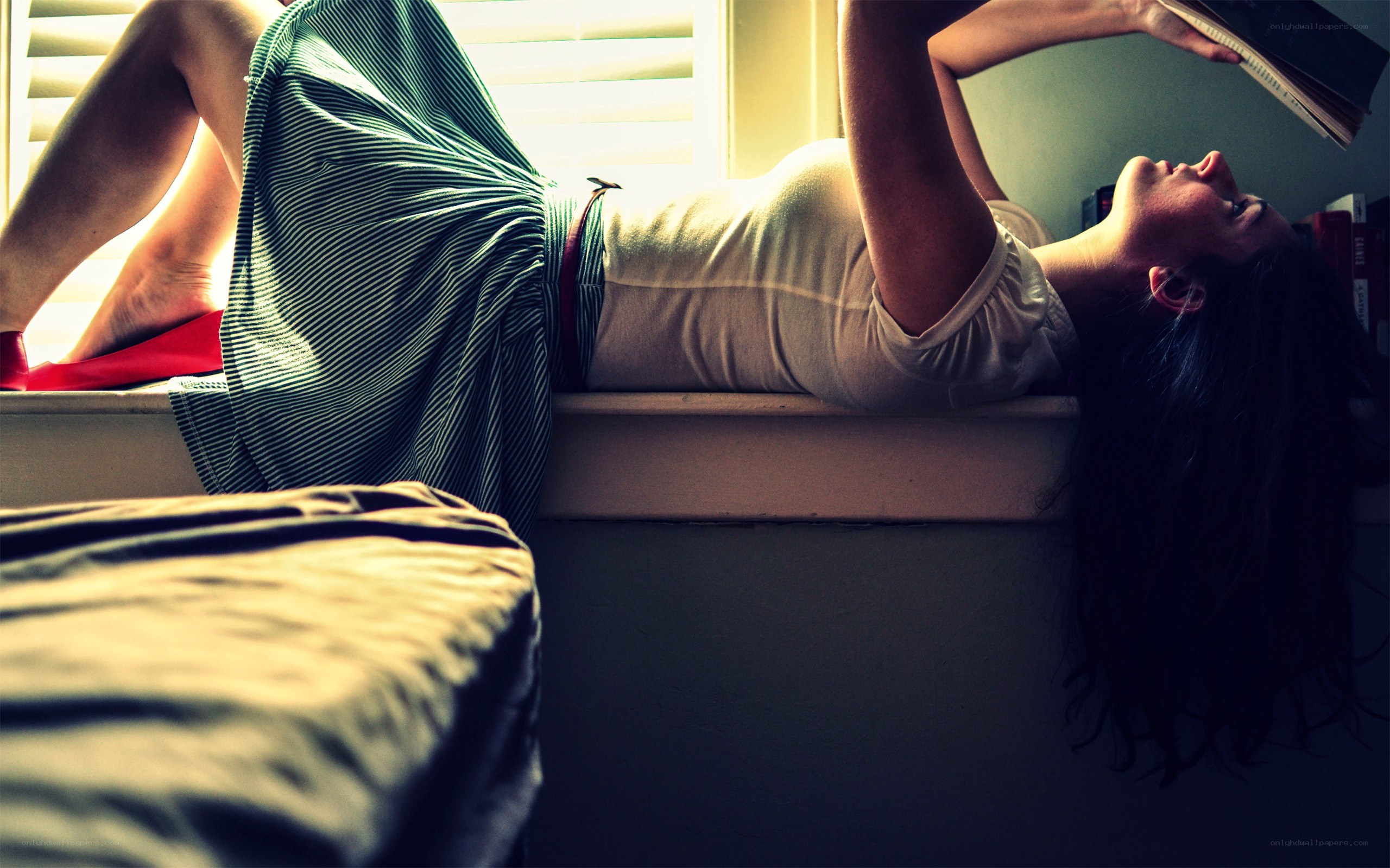 woman reading on windowsill