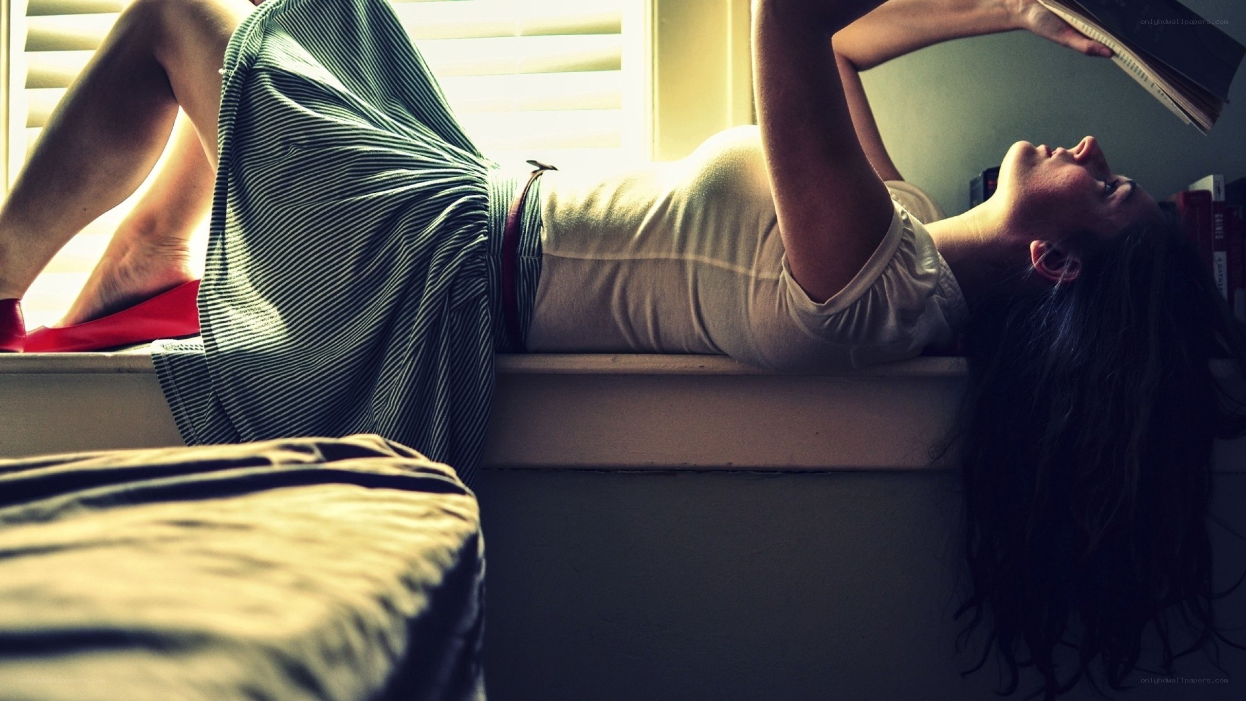 woman reading on windowsill
