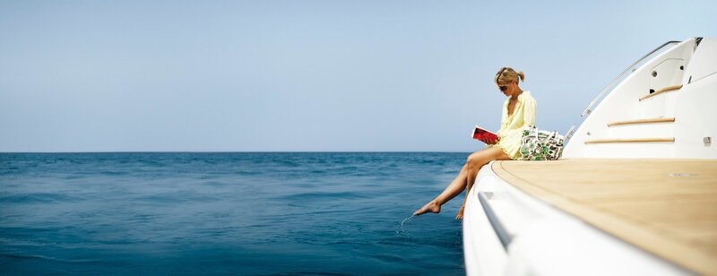 Woman Reading on Yacht