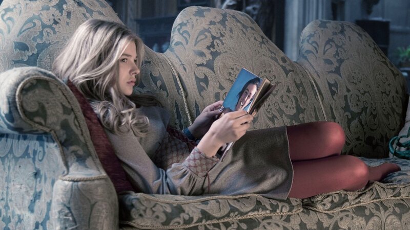 woman reading photo on couch