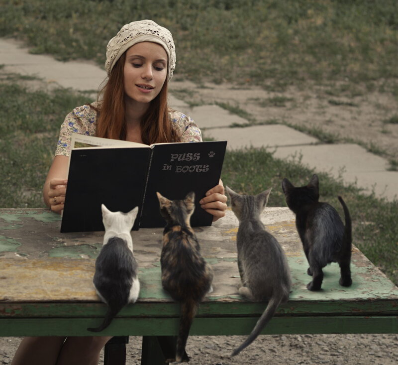 Woman Reading to Kittens