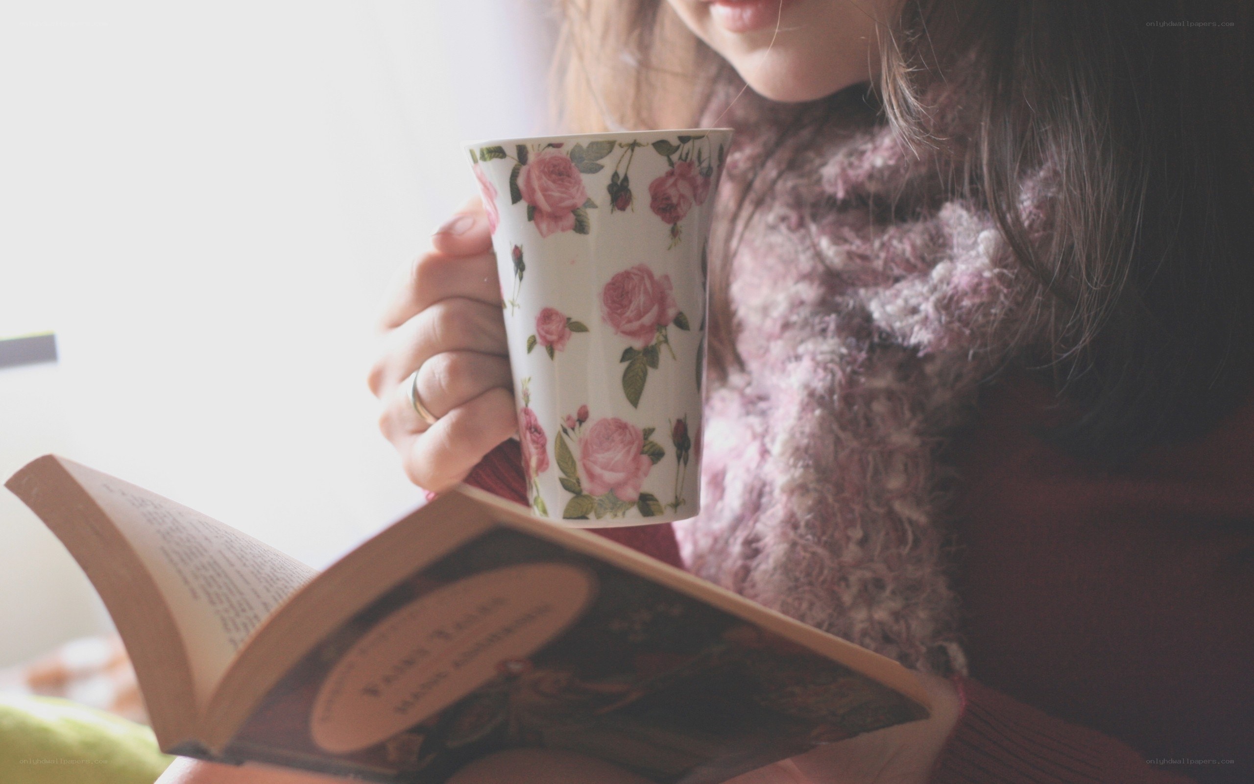 woman reading with a mug
