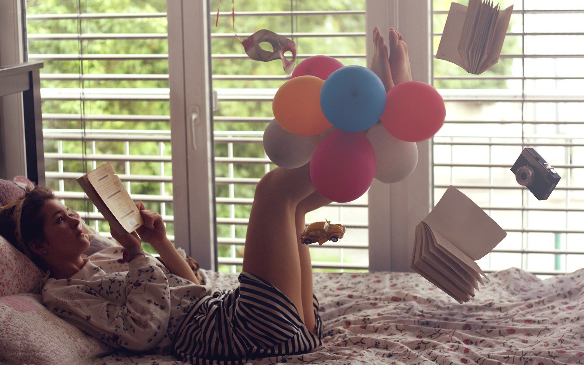 woman reading with balloons