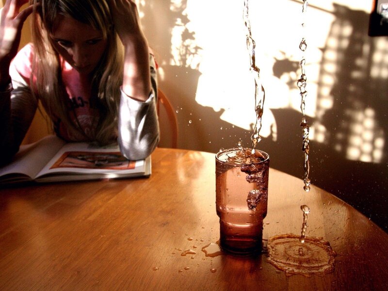Woman reading with spilled drink