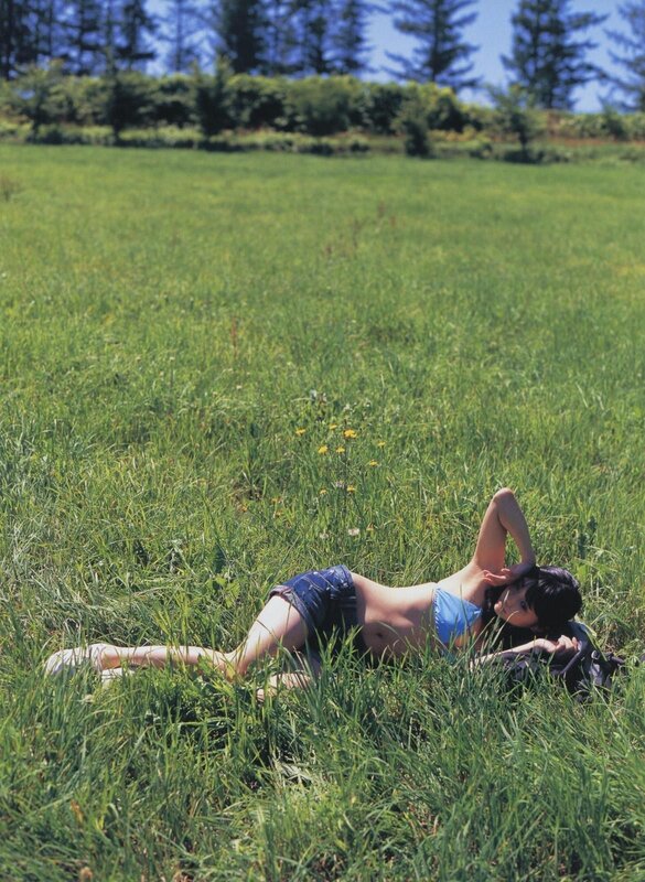 Woman relaxing in a grassy field