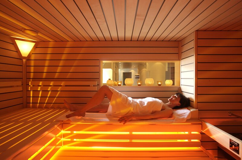 Woman relaxing in a sauna