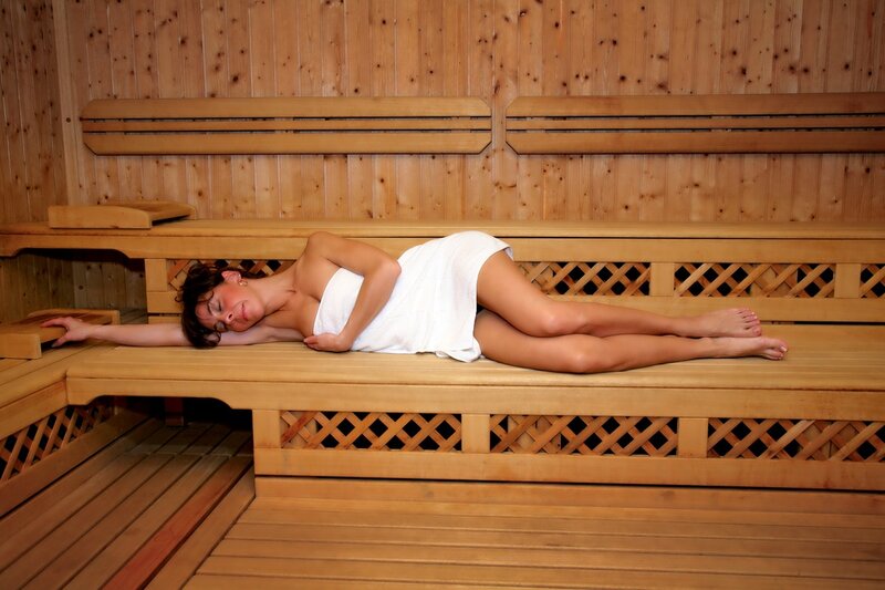 Woman relaxing in a sauna