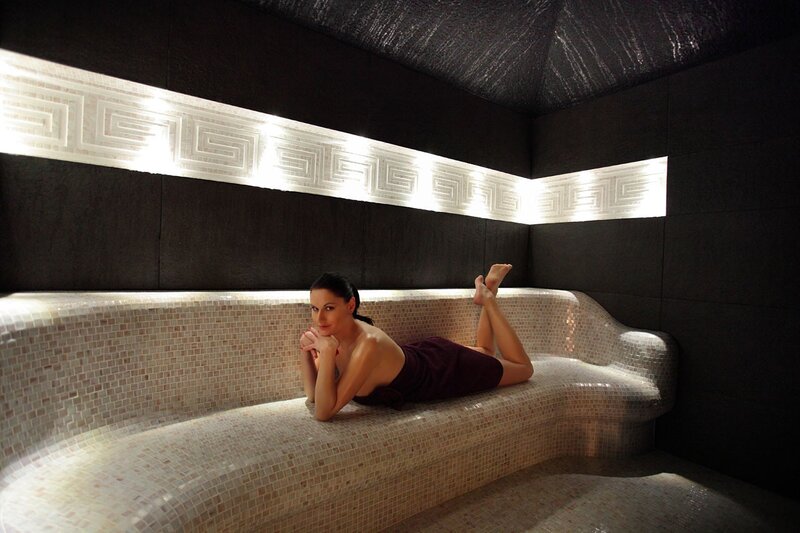 Woman relaxing in a sauna