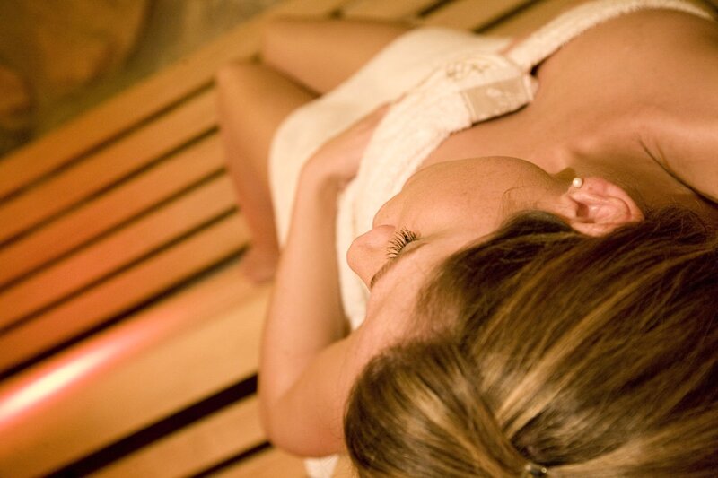 Woman relaxing in a sauna