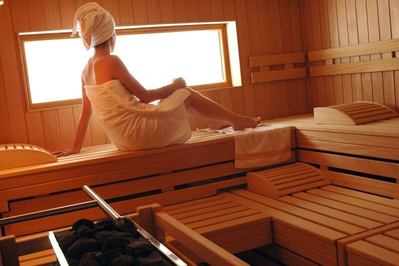 Woman relaxing in a sauna