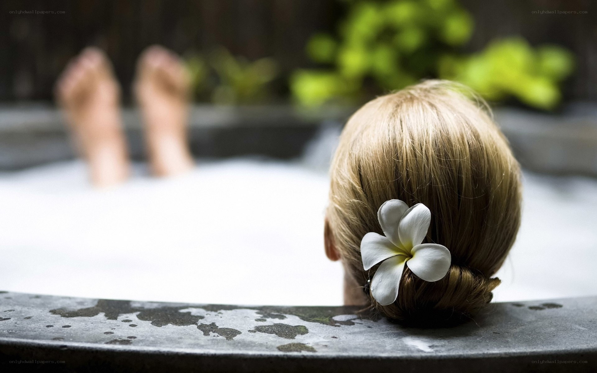 Woman relaxing in a spa tub