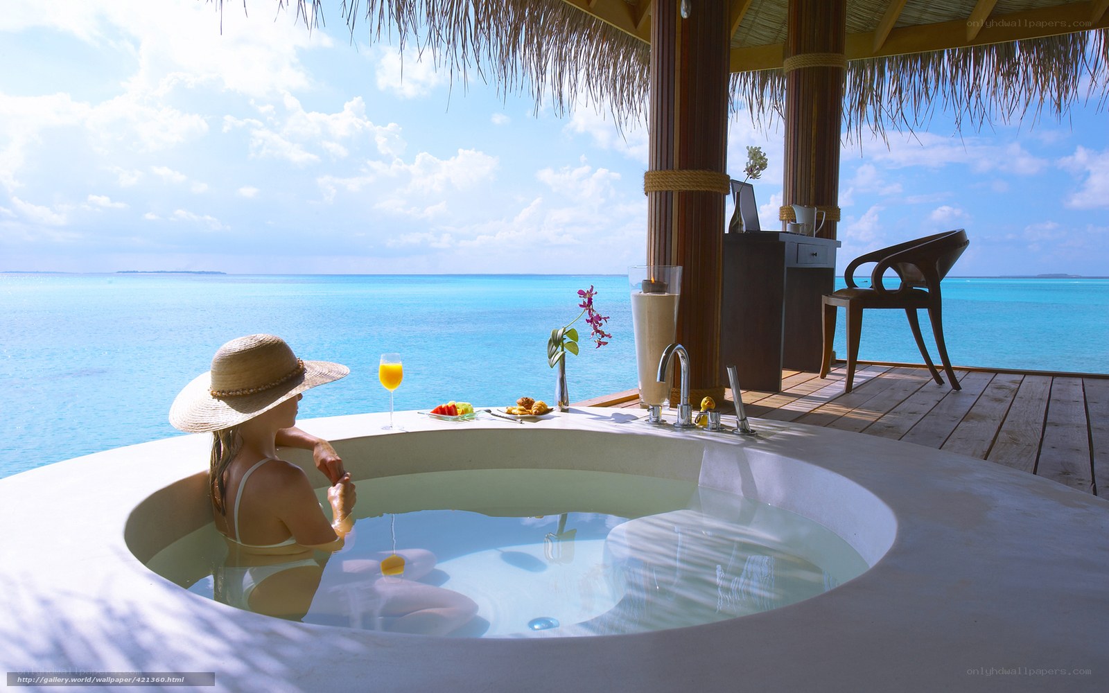 Woman relaxing in ocean-view tub