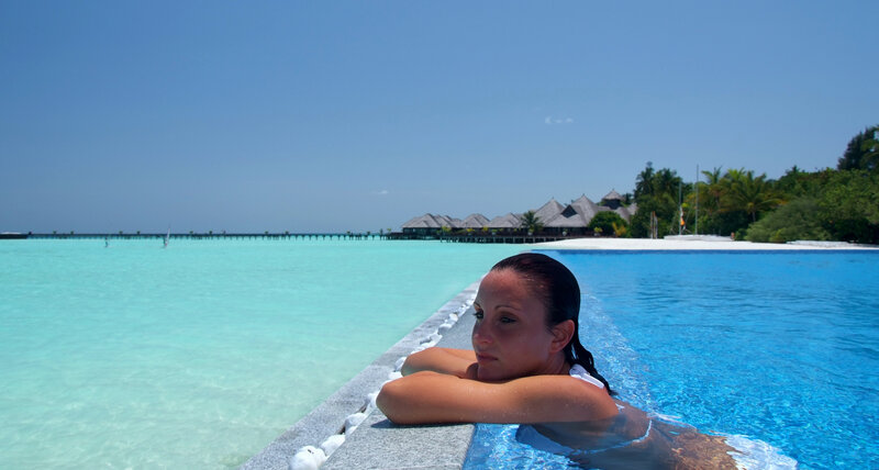 Woman relaxing in pool at resort
