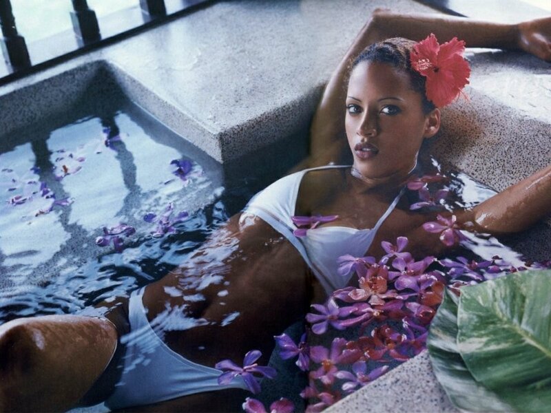 woman relaxing in spa with flowers