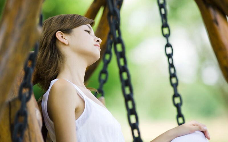woman relaxing on a swing