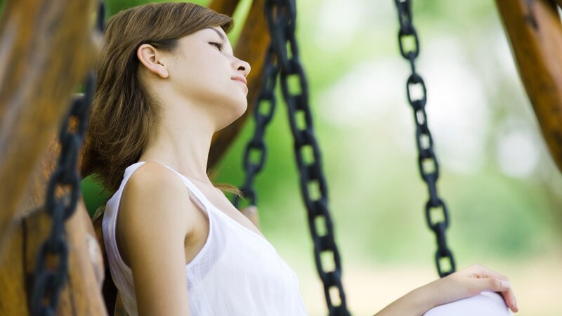 woman relaxing on a swing