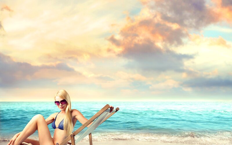 Woman relaxing on beach at sunset