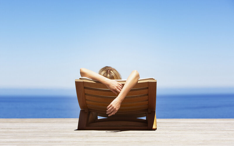 Woman relaxing on deck chair