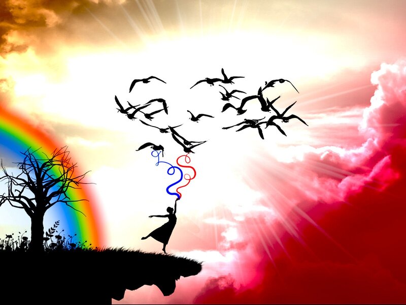 woman releasing birds at sunset