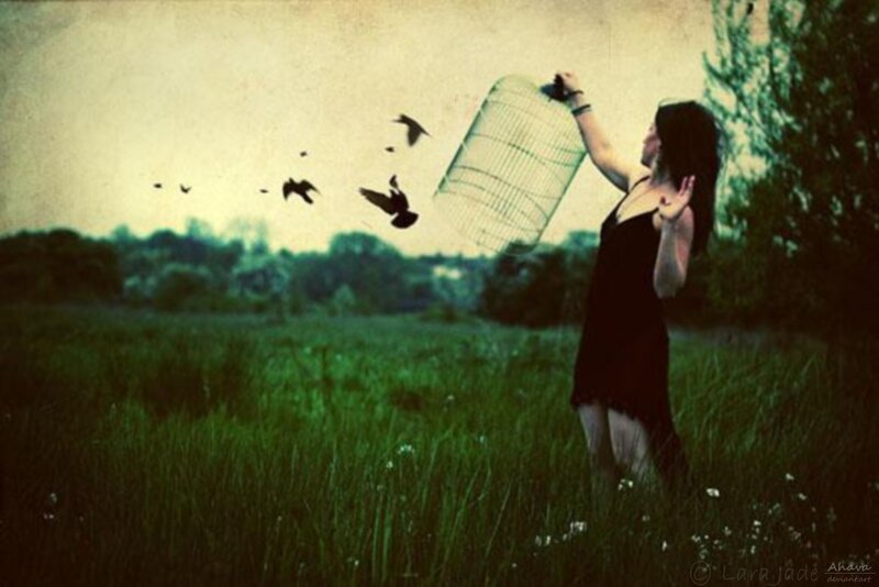 woman releasing birds from a cage