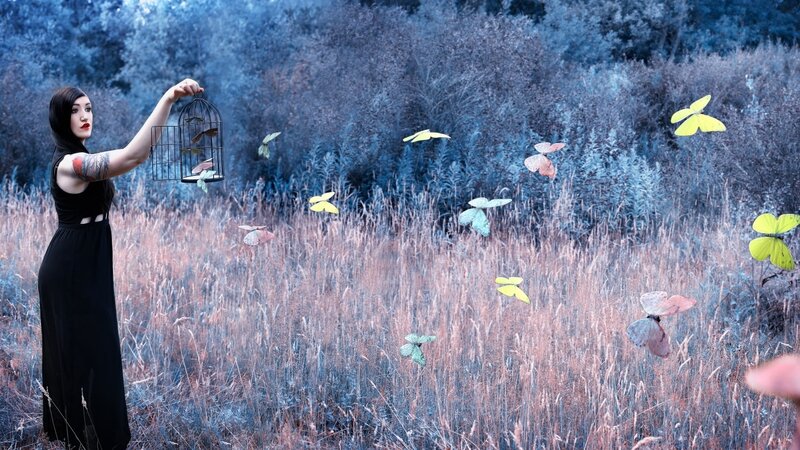 Woman Releasing Butterflies — Blue
