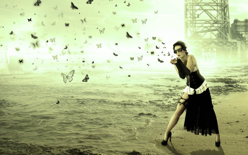 woman releasing butterflies on beach