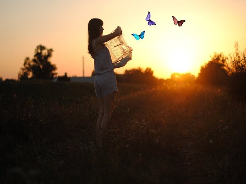Woman Releasing Butterflies — Orange