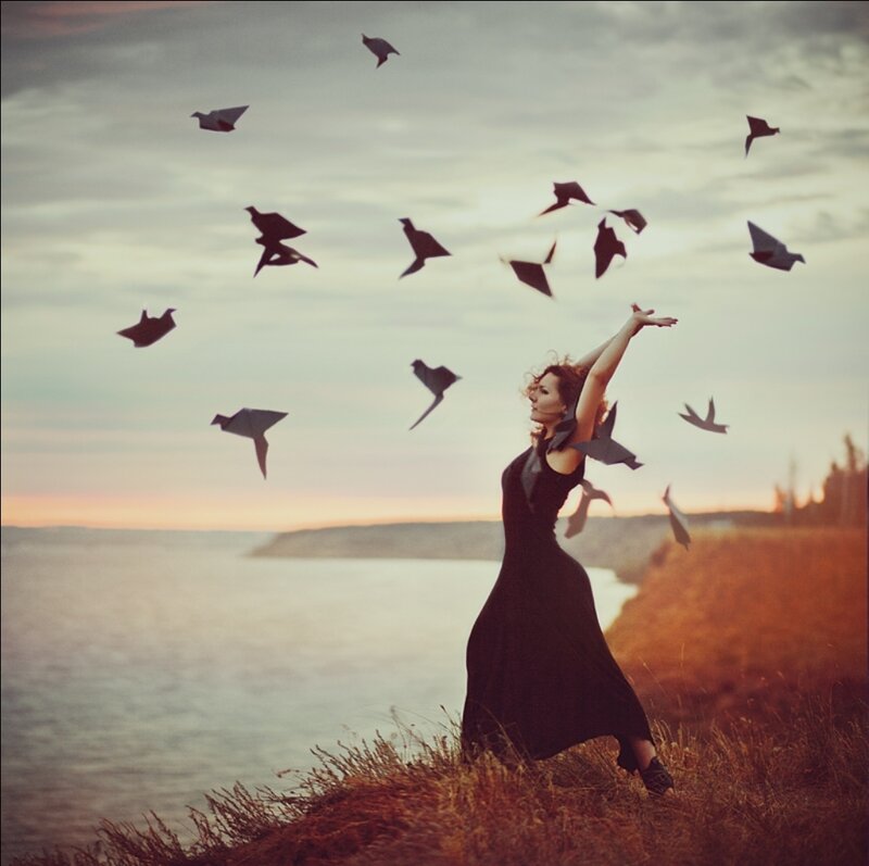 Woman Releasing Origami Birds