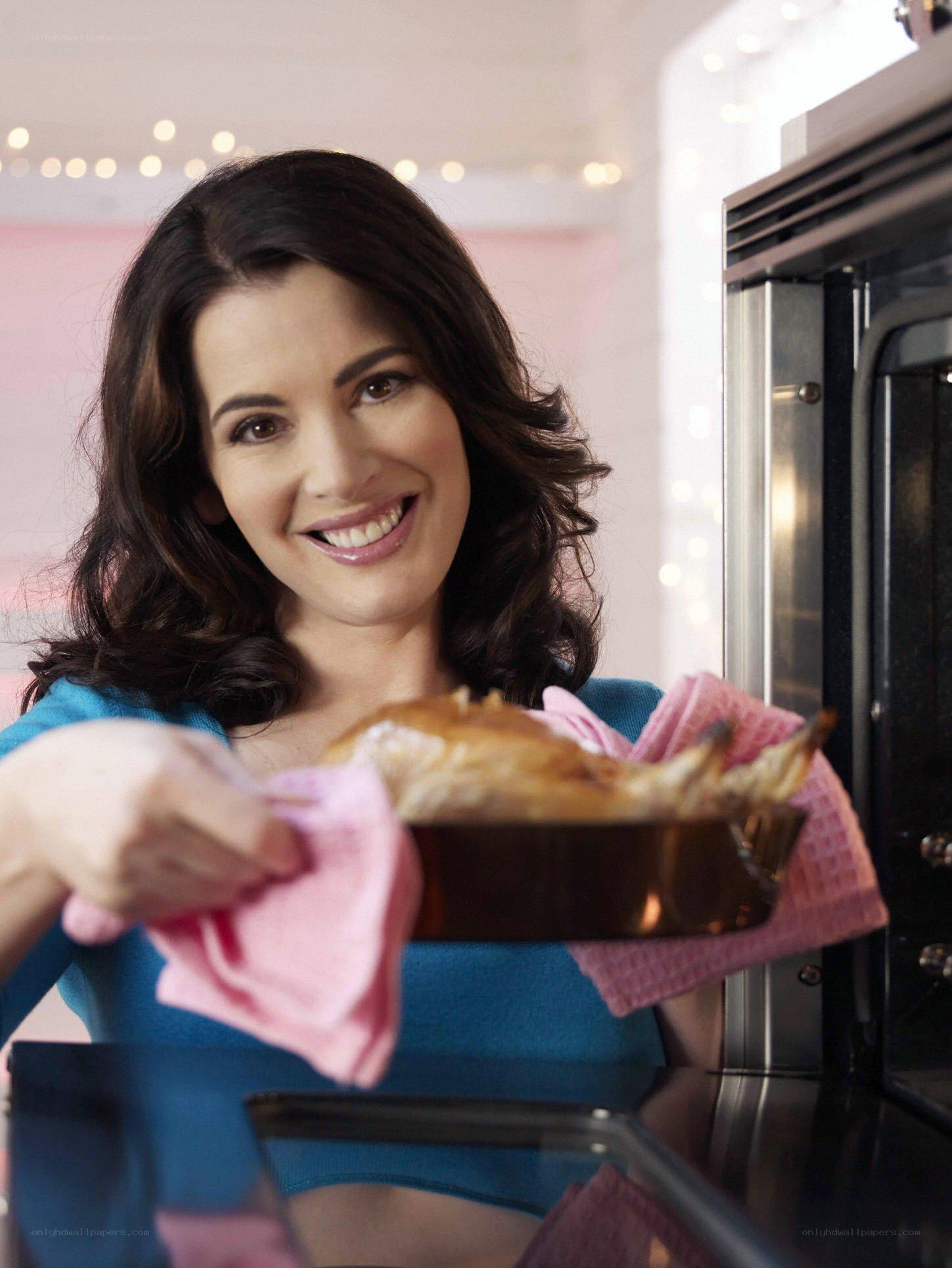 woman removing pie from oven
