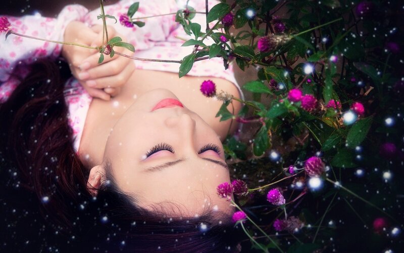 woman resting among flowers