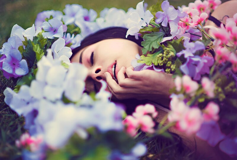 woman resting among flowers