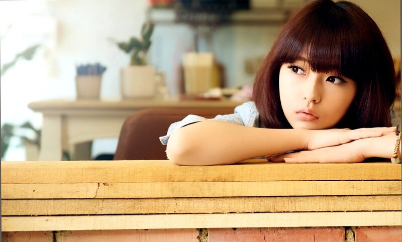 woman resting at wooden table