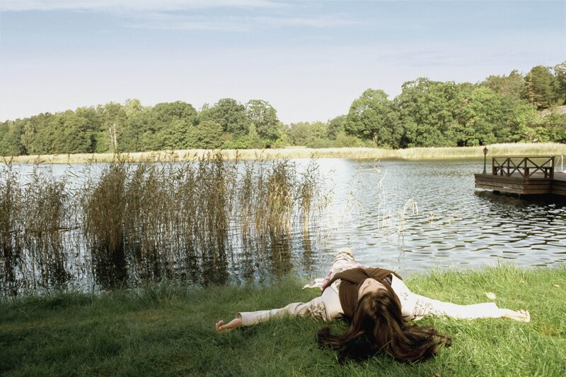 Woman resting by a lake