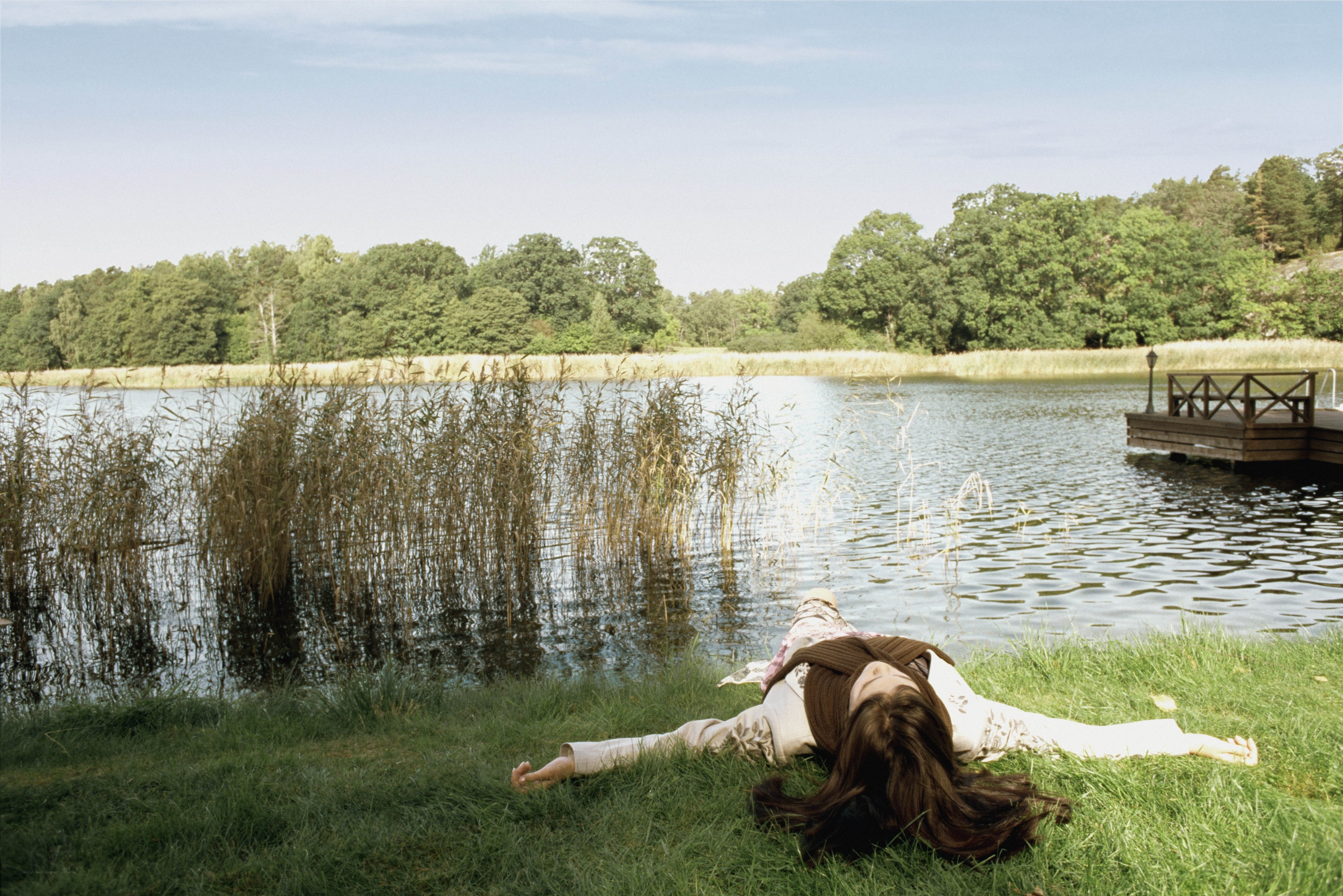 Woman resting by a lake