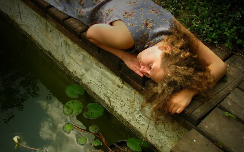 Woman resting by a pond