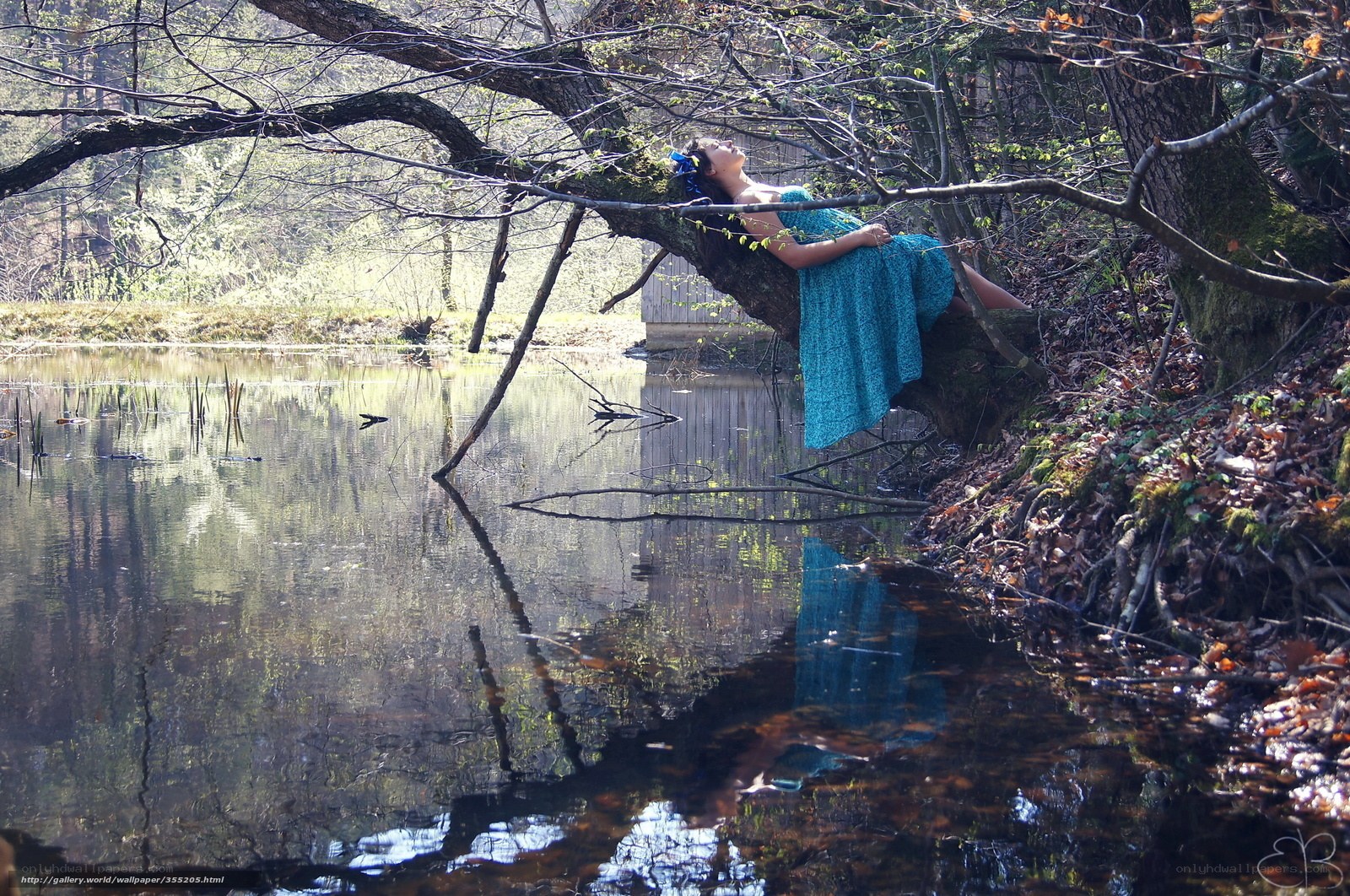 Woman resting by a pond