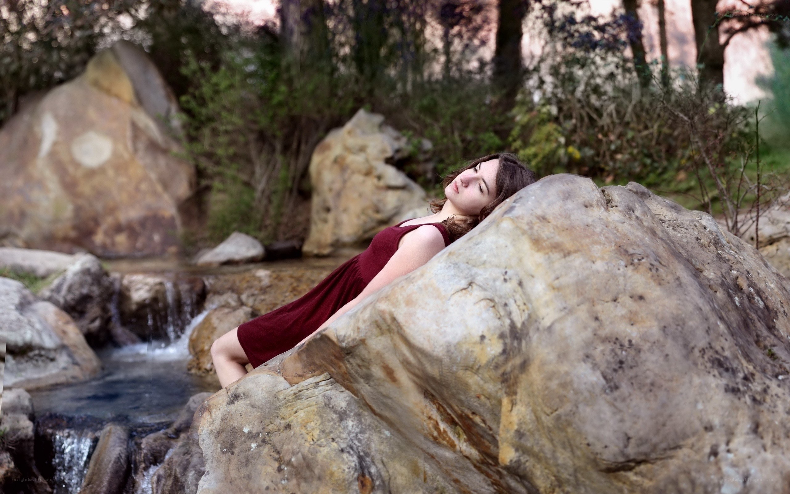 Woman resting by a stream