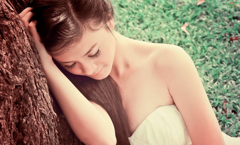 woman resting by a tree