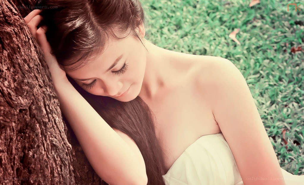 woman resting by a tree