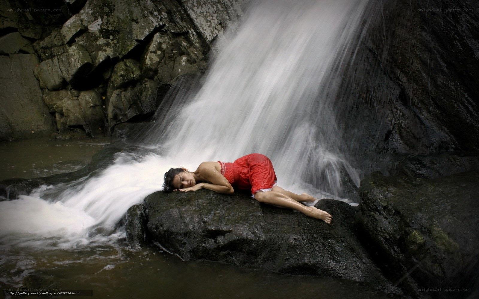 Woman resting by a waterfall
