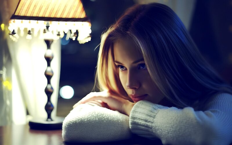 woman resting by lamp