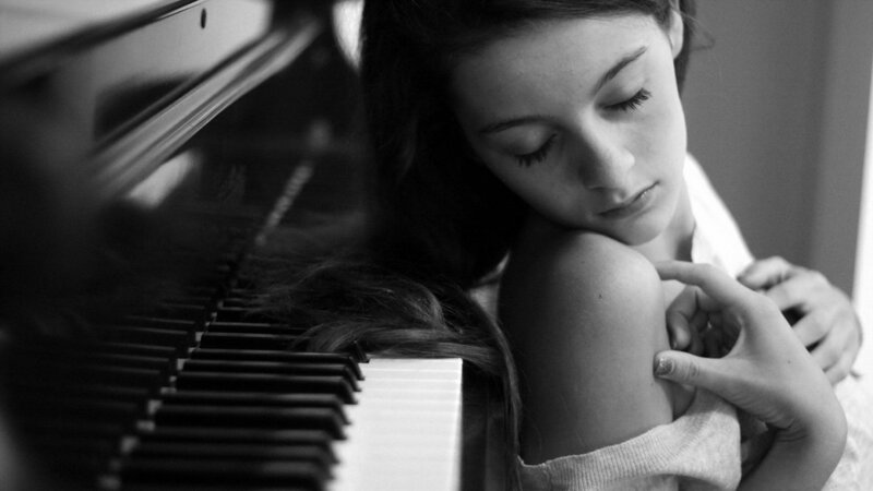 woman resting by piano